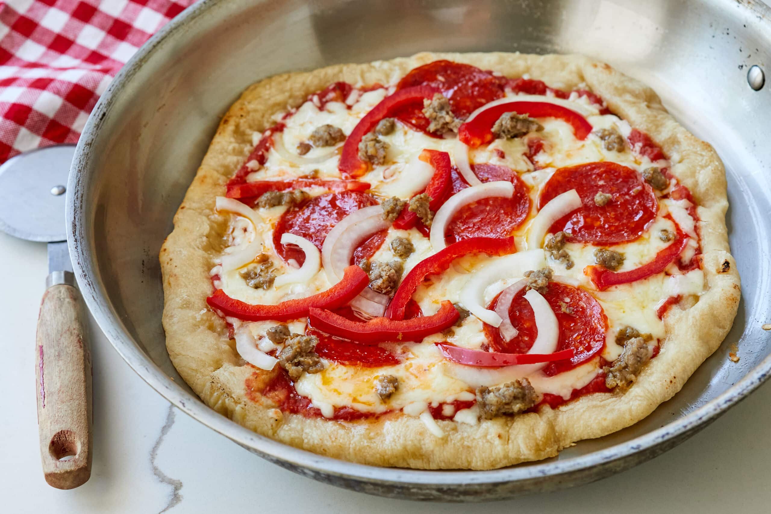 Pan-Fried Pizza (Stovetop, no oven) has a crispy-edge crust loaded with melted cheese, peppers, sausages, and pepperoni
