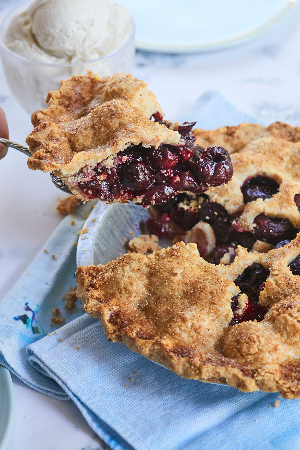 A slice of classic cherry pie recipe to show texture and color.