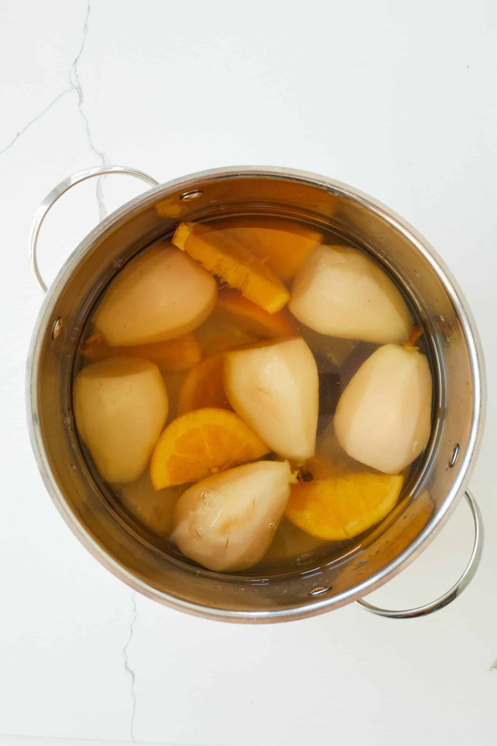 Step-by-step instructions on poaching pears: Keep water at a very gentle simmer and cook until the pears can be easily pierced through.