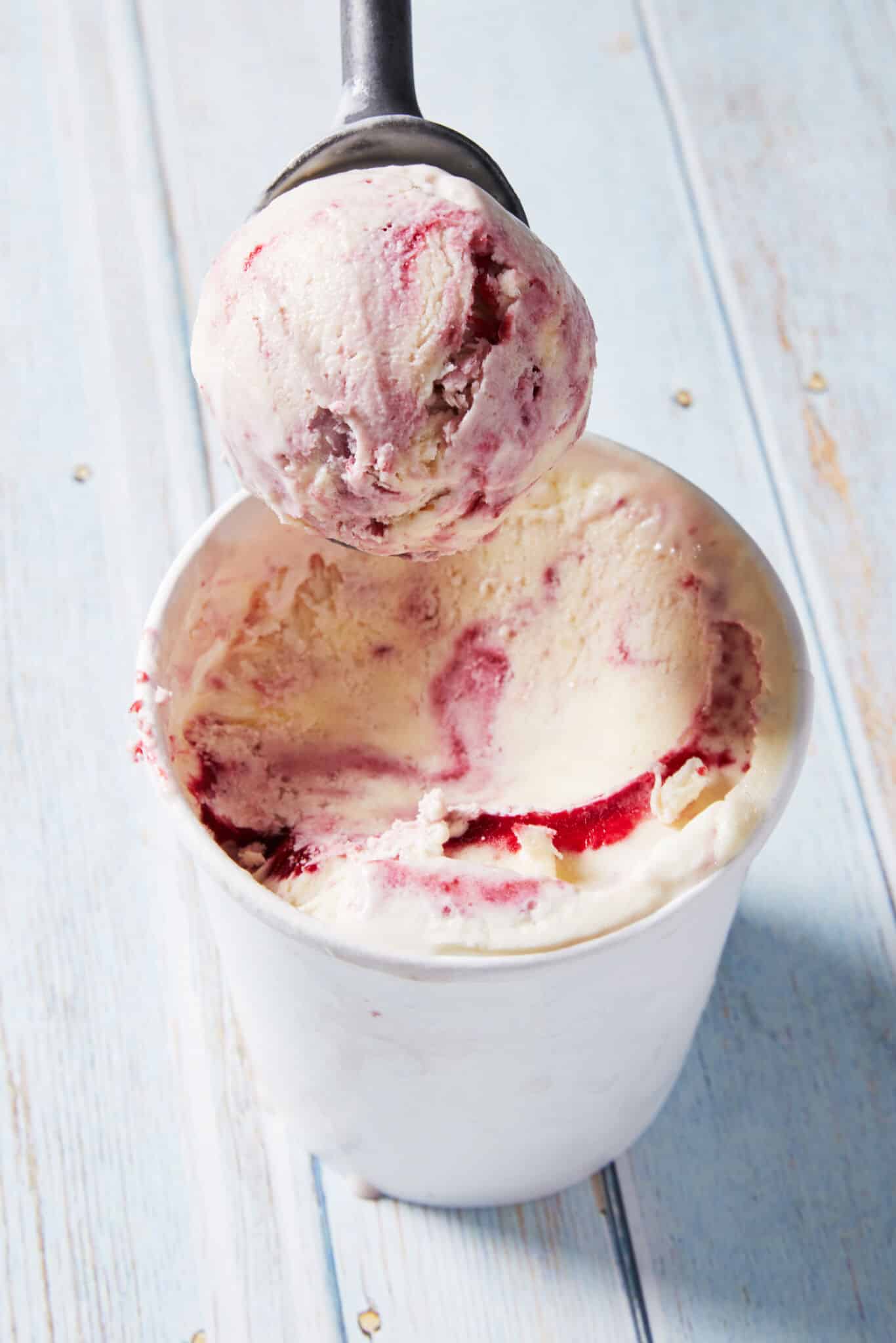A close-up shot at a scoop of the Raspberry Ripple Flavor No-Churn Artisanal Ice Cream shows its thick and creamy consistency.