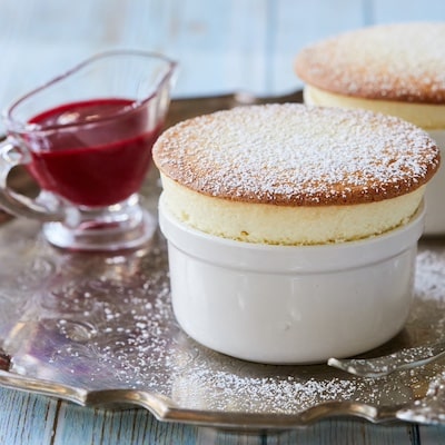 Air-light, elegant white chocolate soufflé is dusted with powdered sugar and served with fresh Raspberry sauce.