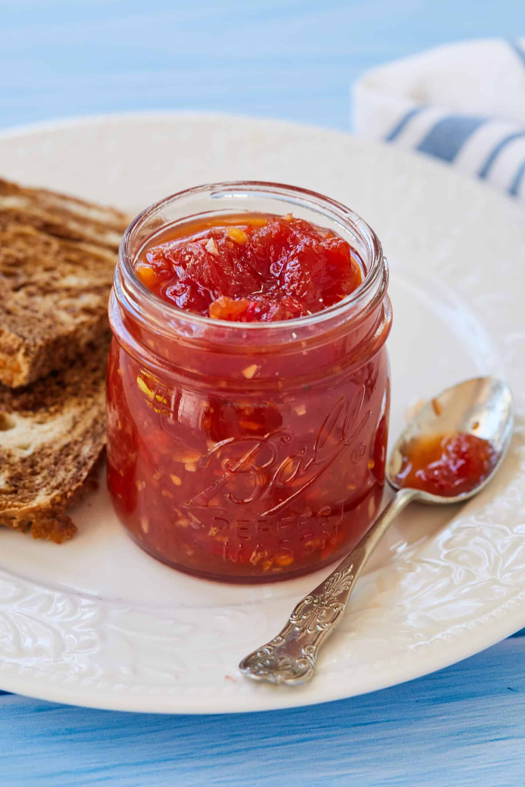 An jar of Tomato Chilli Chutney served with toast