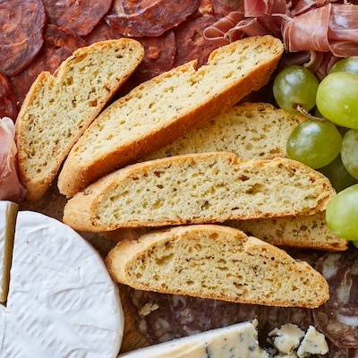 Savory biscottis served with pepperoni , salami, cheese and grapes