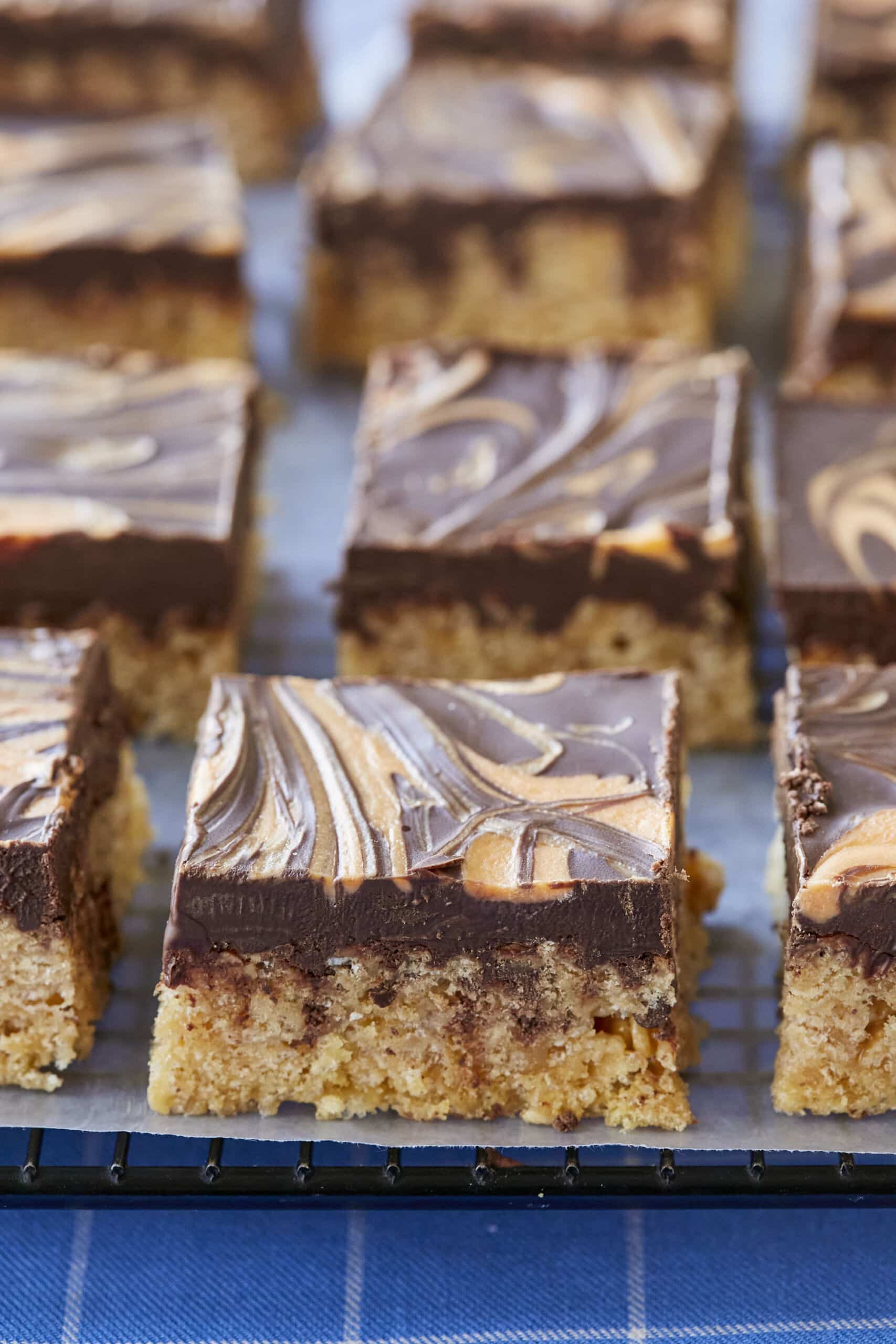 A close-up shot at Easy Scotcheroos shows these layered treats featuring a base of crispy rice cereal with a milk chocolate, peanut butter and butterscotch topping.