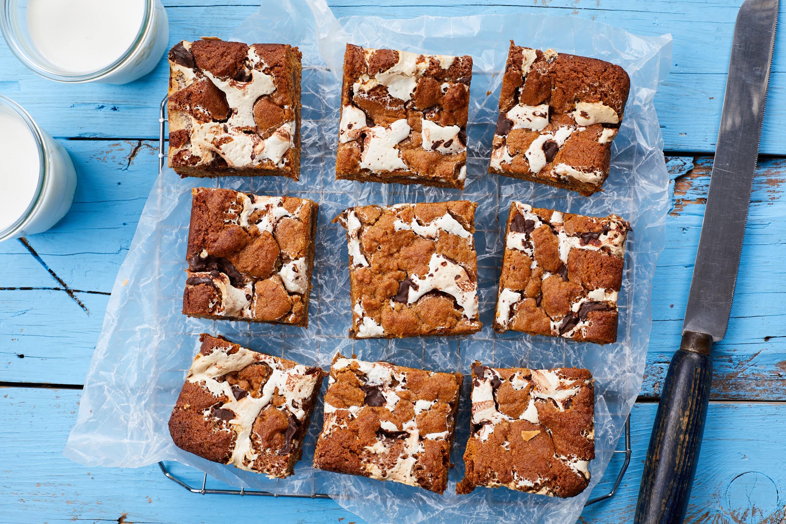An over-head shot at nine generous squares of Smores bars shows the crinkle top, goes chocolate and marshmallow fluff.