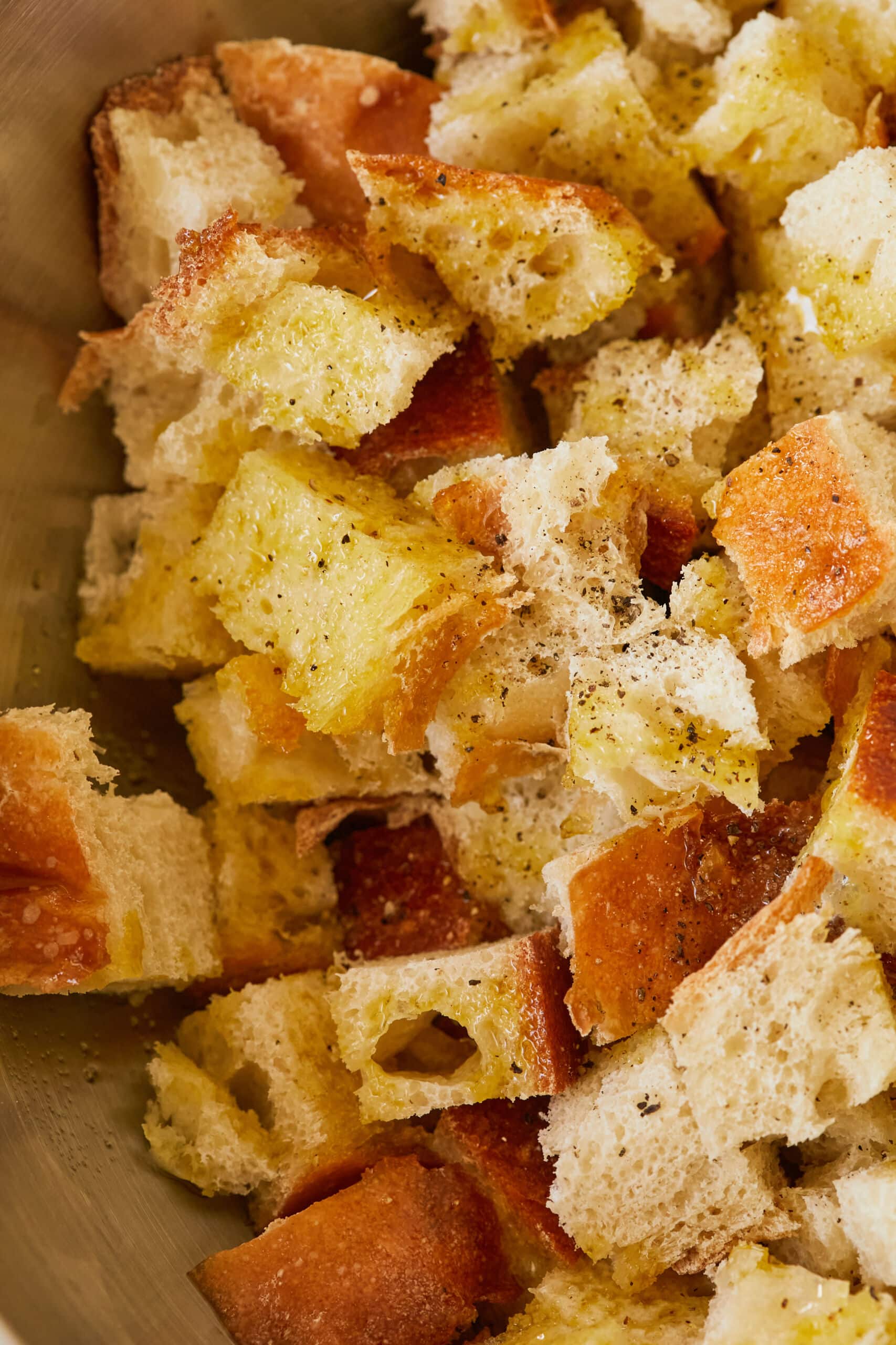 Homemade croutons are baked golden and crispy, tossed with seasoning.